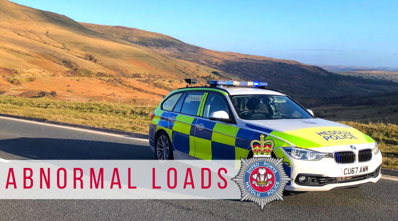 The words 'abnormal loads' overlayed on a picture of a police car