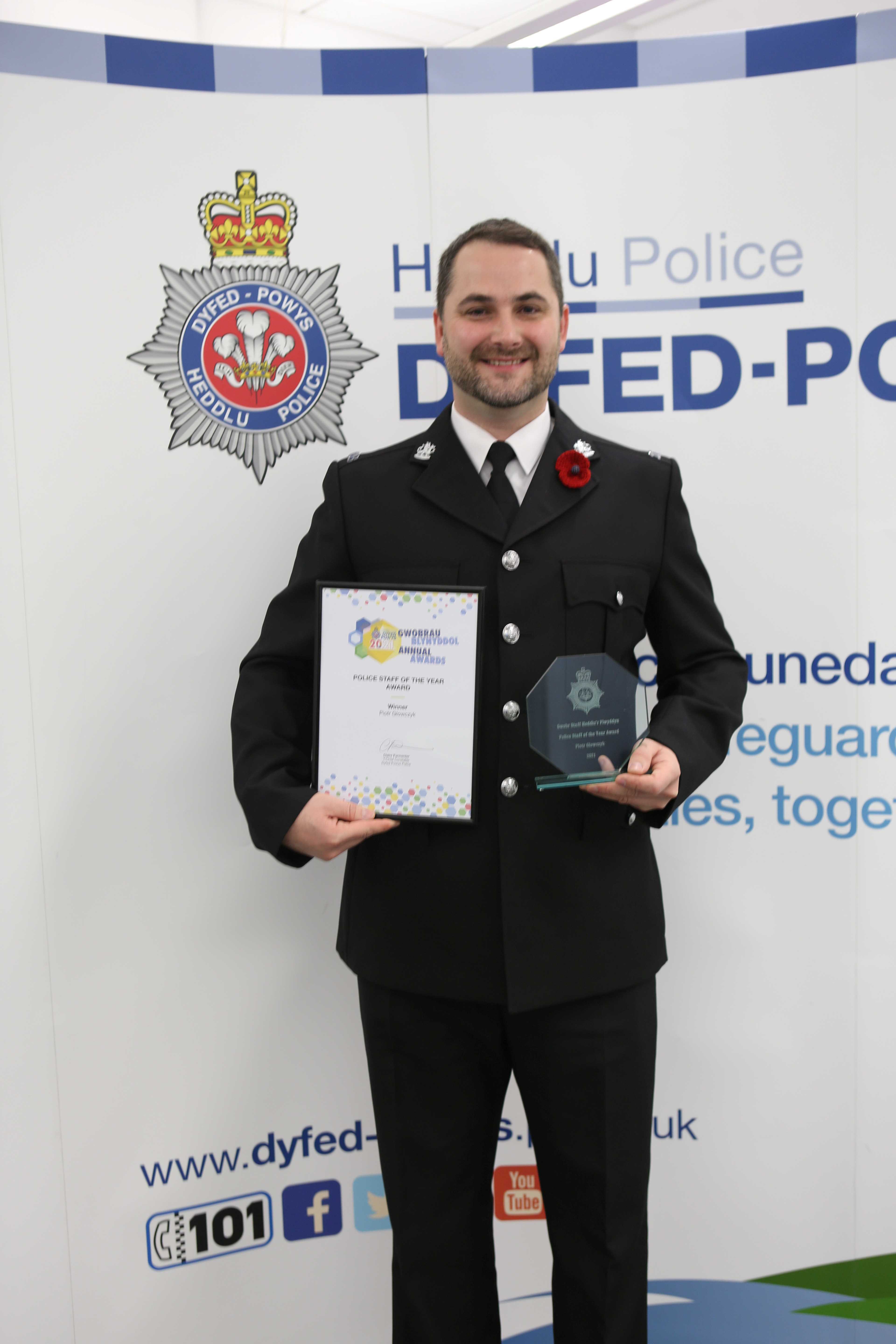 Former PCSO Piotr Glowczyk with his awards for police staff of the year.