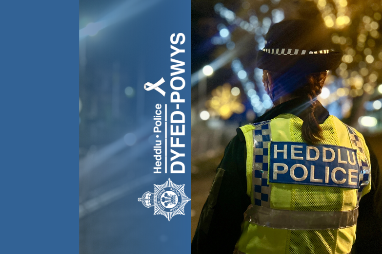 Photo of a female police officer patrolling at night time