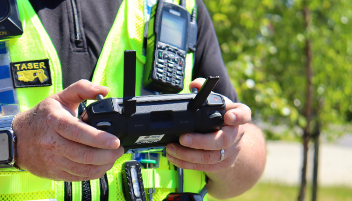An officer piloting a drone