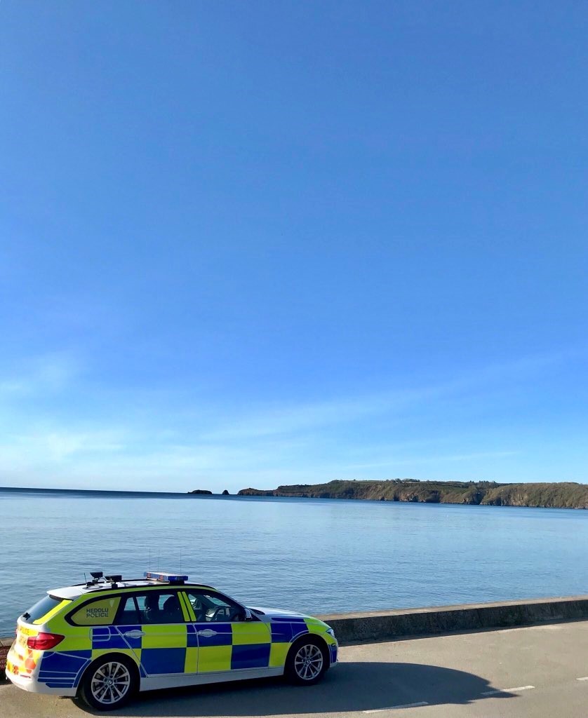 photo of police car near sea