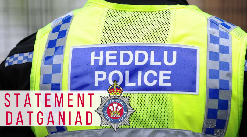 Stock image of the back of a high vis police vest with the word 'statement' overlaid in red text