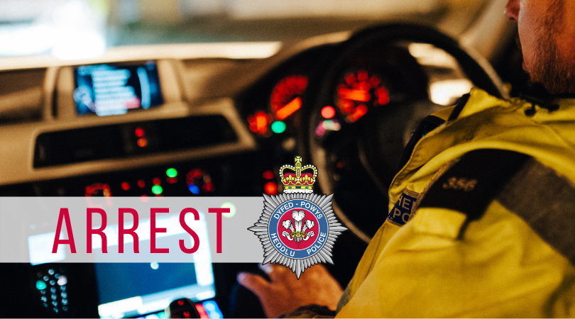 Force crest on a photograph inside a police car. Text says: arrest.