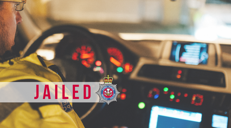 Stock image of a police officer in a police car