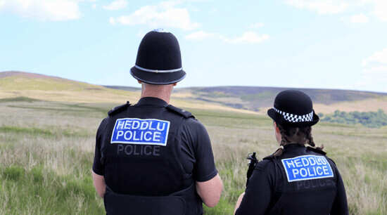 two officers overlooking rural fields